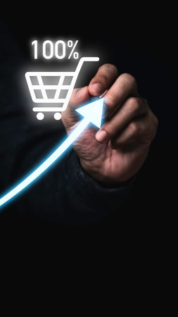 A hand draws a glowing blue arrow indicating growth towards a shopping cart icon with 100% displayed.の写真素材