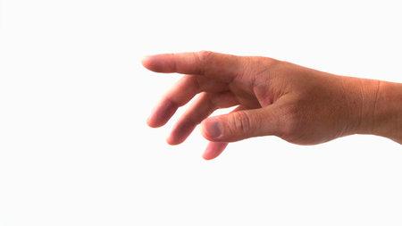 A human hand with fingers slightly curled, reaching forward against a clean white backdrop. The gesture suggests interaction or selection.の写真素材