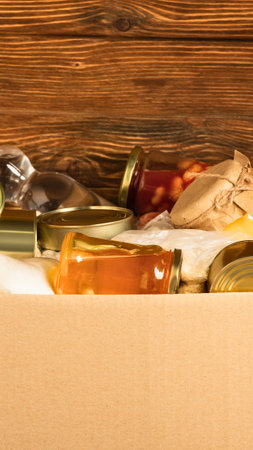 Several glass jars filled with golden honey are arranged on a textured wooden background.の写真素材
