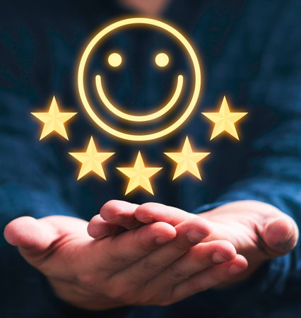 Open hands hold a glowing smiley face surrounded by five golden stars, representing excellent...