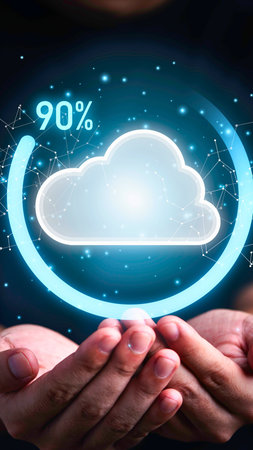 A digital cloud icon glows brightly above cupped hands, surrounded by a loading circle showing 90 percent completion.の写真素材