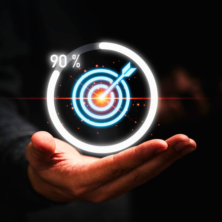 A person's open hand supports a luminous circular graphic displaying a target with an arrow and a 90 percent progress indicator.の写真素材