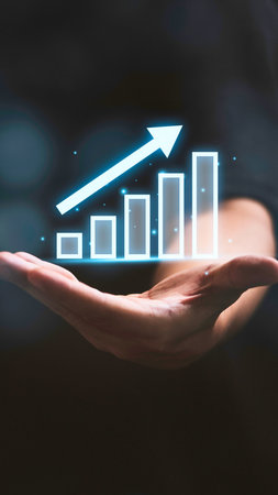 A hand cradles a glowing bar graph with an arrow indicating positive financial growth and success.