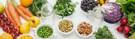 A colorful and abundant collection of fresh produce, including carrots, berries, leafy greens, and various vegetables, arranged for a healthy food display.の写真素材