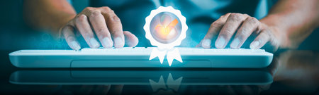 Close-up of hands typing on a keyboard, with a glowing portal of light emerging from the center, symbolizing digital creation.の写真素材