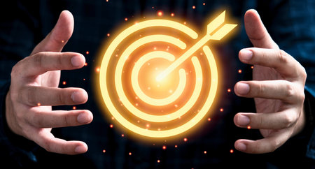 Two hands are outstretched towards a bright, glowing target with an arrow in the bullseye, symbolizing focus and achievement.の写真素材