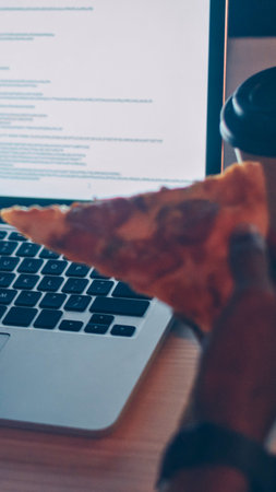 A person wearing a virtual reality headset is actively typing on a laptop keyboard, suggesting immersive digital interaction.の写真素材