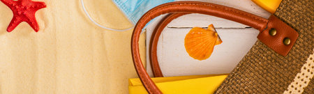 A detailed view of a handbag's strap and textured material, featuring a vibrant orange charm hanging from a string.の写真素材