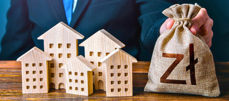 Miniature houses arranged in an upward trend next to a money bag with the Polish Zloty symbol.