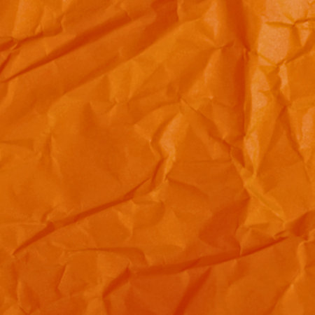 A detailed, abstract view of a crinkled orange textile, showcasing its textured surface and rich color saturation.の写真素材