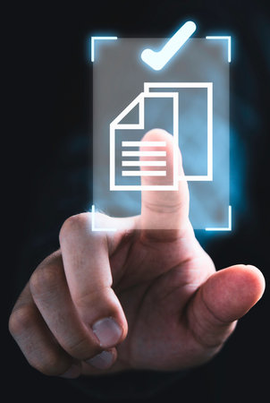 A finger interacts with a glowing digital interface, selecting a document icon signifying approval or completion.の写真素材