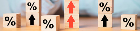 Wooden blocks with percentage signs and red upward arrows visually represent financial growth, interest rate increases, or positive economic trends.の写真素材