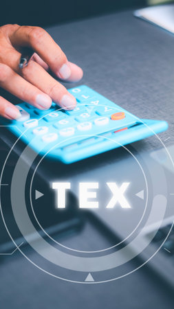 A person's hand with a ring is shown pressing buttons on a calculator.の写真素材