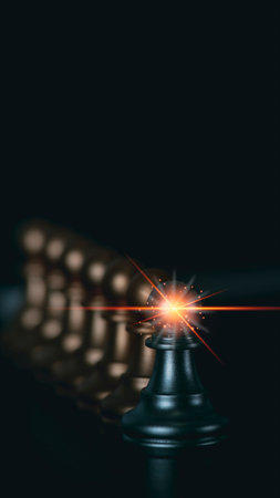 A macro shot shows a bright orange fuse igniting with a starburst effect against a deep black backdrop.の写真素材