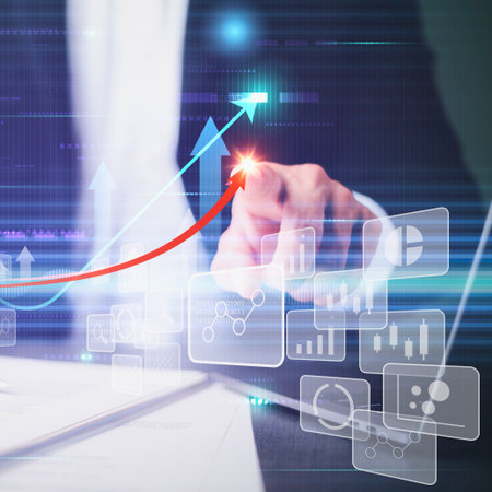 A hand interacts with a holographic display showing financial data, charts, and an upward trending arrow indicating business growth and success.の写真素材