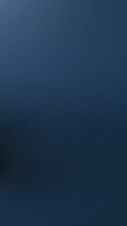 A deep, dark blue abstract background with subtle, almost imperceptible horizontal lines or texture. Evokes a sense of calm and depth.の写真素材