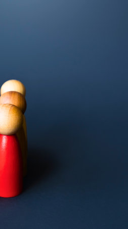 A bright red megaphone sits on a dark blue surface, topped with a stack of golden brown bread rolls.の写真素材