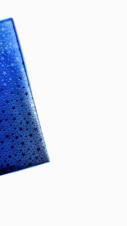 A detailed view of a vibrant blue material featuring a rough texture and numerous tiny dark specks scattered across its surface.の写真素材