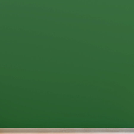 A deep, rich green background with a subtle, textured appearance. The lighting creates gentle variations in shade and tone across the surface.の写真素材