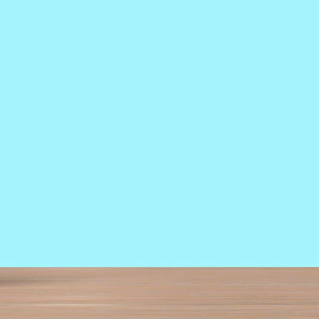 A simple, clean background featuring a light blue wall meeting a warm, light brown wooden floor.の写真素材
