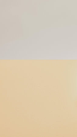 A minimalist, abstract depiction of a sandy beach meeting a pale sky with a soft color transition. Serene and tranquil.の写真素材