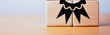 Two wooden blocks are joined to create a stylized figure. A black, abstract design adorns the front of the blocks.の写真素材