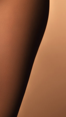 An abstract, close-up view of human skin showcasing texture and the interplay of light and shadow.の写真素材