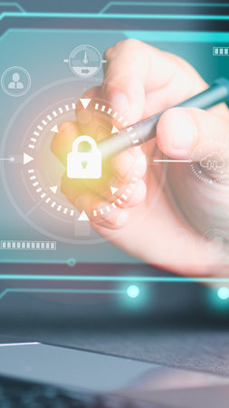 A close-up of a hand using a stylus to interact with a glowing digital interface displaying a security lock icon.の写真素材