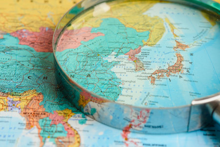 A detailed close-up shot of a globe, highlighting the continent of Asia and its surrounding blue oceans.の写真素材