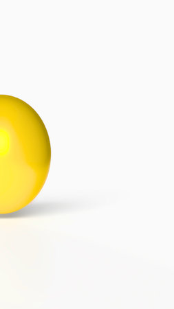 A solitary, vibrant yellow Easter egg rests on a stark white surface, its shadow subtly cast to the right.の写真素材