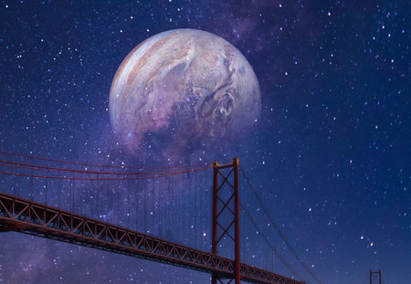 A surreal scene depicts a large, detailed planet hanging in a starry, purple-hued night sky above a bridge.の写真素材