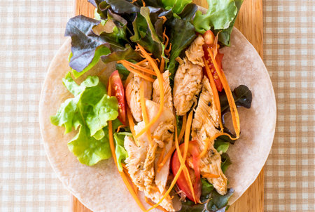 A close-up overhead view of vibrant spring rolls filled with succulent shrimp and crisp vegetables, artfully arranged on a light-colored plate.の写真素材