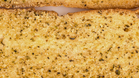 A detailed, textured view of freshly baked cornbread, showcasing its crumb and embedded ingredients. The warm, golden hue suggests deliciousness.の写真素材