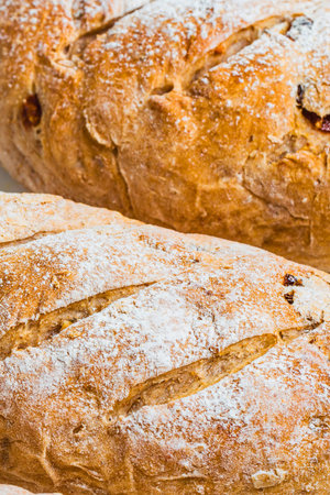 Two crusty baguettes with a golden brown exterior and a light dusting of flour, showcasing their textured surfaces.の写真素材