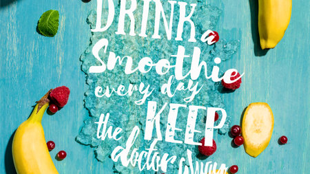 A vibrant flat lay of fresh fruit and mint leaves arranged around a motivational quote about smoothies, set against a textured blue surface.の写真素材