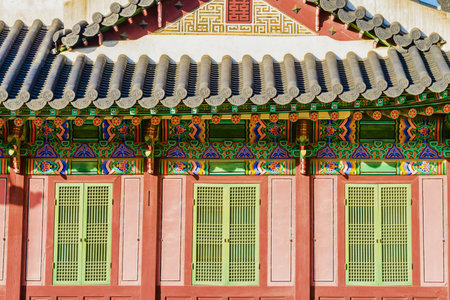 Close-up view of the ornate architectural details of a traditional Korean palace, showcasing vibrant colors and intricate patterns.の写真素材