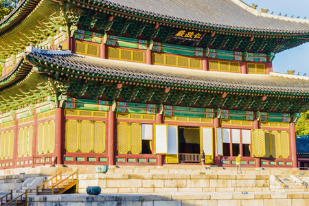 A detailed view of a historic Korean palace structure, showcasing intricate architectural elements and vibrant painted decorations.の写真素材