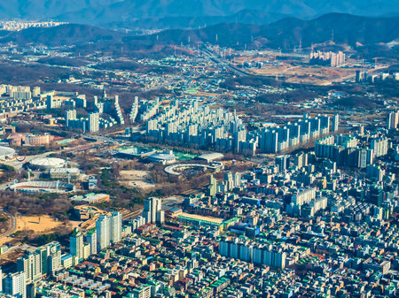 An expansive aerial view showcasing a sprawling urban environment filled with numerous high-rise apartment buildings and city infrastructure.の写真素材