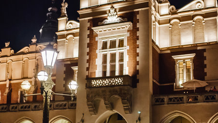 A grand, ornate building with intricate architectural details is beautifully lit by warm lights at night, showcasing its historical significance.の写真素材