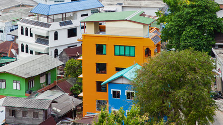 An aerial view showcases a vibrant collection of buildings with diverse architectural styles and bright colors, nestled closely together.の写真素材