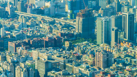 An aerial view showcases a dense, sprawling metropolis with countless skyscrapers and intricate road networks stretching into the distance.の写真素材