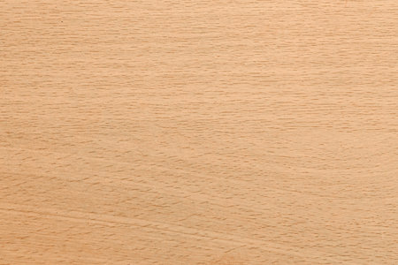 A close-up, seamless texture of light brown wood grain with subtle variations in color and fine linear patterns.の写真素材