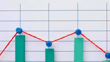 A close-up of a grid with a red line graph and green bar chart made from clay, showing fluctuating data.の写真素材