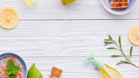 A vibrant flat lay showcases fresh fruits, herbs, and a small dish of food arranged on a rustic white wooden surface, creating a clean and inviting composition.の写真素材