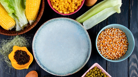 A collection of fresh produce, grains, and seeds are artfully arranged on a rustic dark wooden background, showcasing a healthy and vibrant assortment.の写真素材