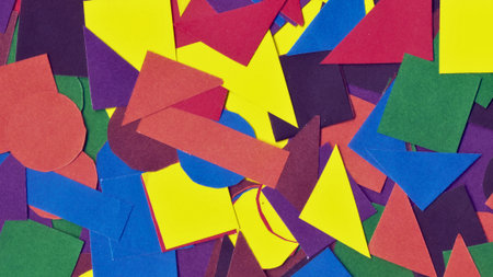 A vibrant and chaotic collage of various abstract geometric shapes in a multitude of bright colors,...