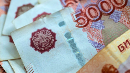 A detailed, close-up view of several Russian 5000 ruble banknotes, showing intricate details and the...