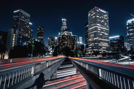 A vibrant night scene of city skyscrapers with bright lights and busy street