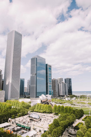 A vibrant cityscape scene showing tall buildings and a green park area.