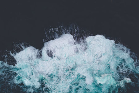 A large iceberg drifting in the dark ocean under night sky, cold and mysterious setting.